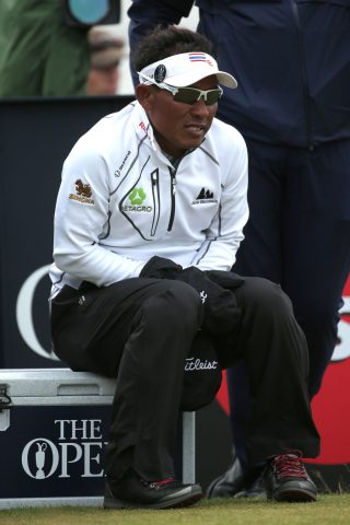 ST ANDREWS, SCOTLAND - JULY 16:  Thongchai Jaidee of Thailand attempts to keep warm on the 17th tee during the first round of the 144th Open Championship at The Old Course on July 16, 2015 in St Andrews, Scotland.  (Photo by Mike Ehrmann/Getty Images)