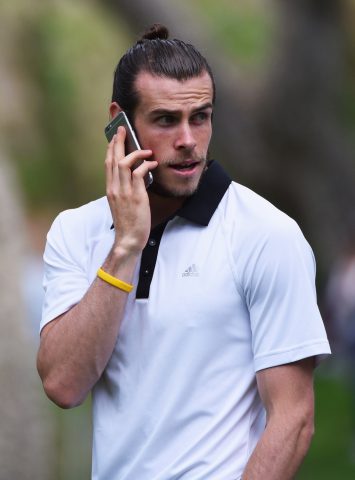 SOTOGRANDE, SPAIN - APRIL 17: Real Madrid and Wales footballer Gareth Bale looks on from the 18th hole as he watches the Sergio Garcia group during the final round on day four of the Open de Espana at Real Club Valderrama on April 17, 2016 in Sotogrande, Spain. (Photo by Ross Kinnaird/Getty Images)