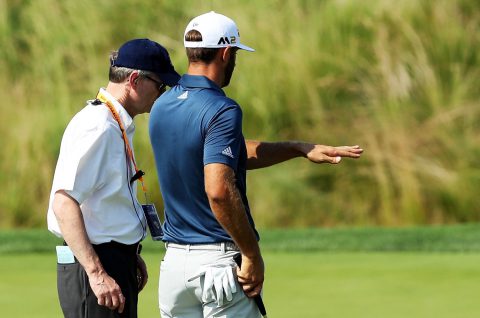 OAKMONT, PA - JUNE 19: Dustin Johnson of the United States chats with a rules official on the fifth green during the final round of the U.S. Open at Oakmont Country Club on June 19, 2016 in Oakmont, Pennsylvania. (Photo by David Cannon/Getty Images)