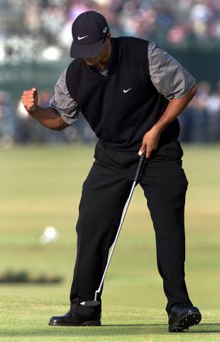ST. ANDREWS, UNITED KINGDOM: Tiger Woods of the US pumps his fist after sinking a putt to save par on the 17th hole after laying his second shot off the back of the green on the Old Course at St. Andrews during his second round of the British Open Championship 21 July 2000. Woods is the second round leader at 11-under par. (ELECTRONIC IMAGE) (Photo credit should read ADRIAN DENNIS/AFP/Getty Images)