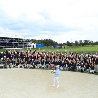 Paul Casey of England celebrates with the trophy in front of volunteers following Day 4 of the Porsche European Open at Green Eagle Golf Course on September 08, 2019 in Hamburg, Germany