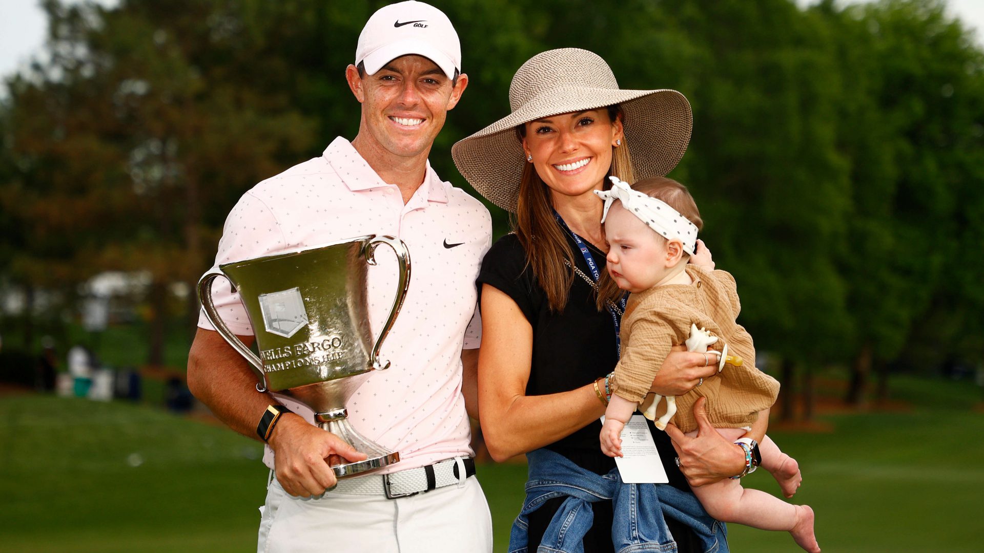 Rory McIlroy of Northern Ireland celebrates with the trophy alongside his wife Erica and daughter Poppy after winning during the final round of the 2021 Wells Fargo Championship at Quail Hollow Club on May 09, 2021 in Charlotte, North Carolina. (Photo by Jared C. Tilton/Getty Images)