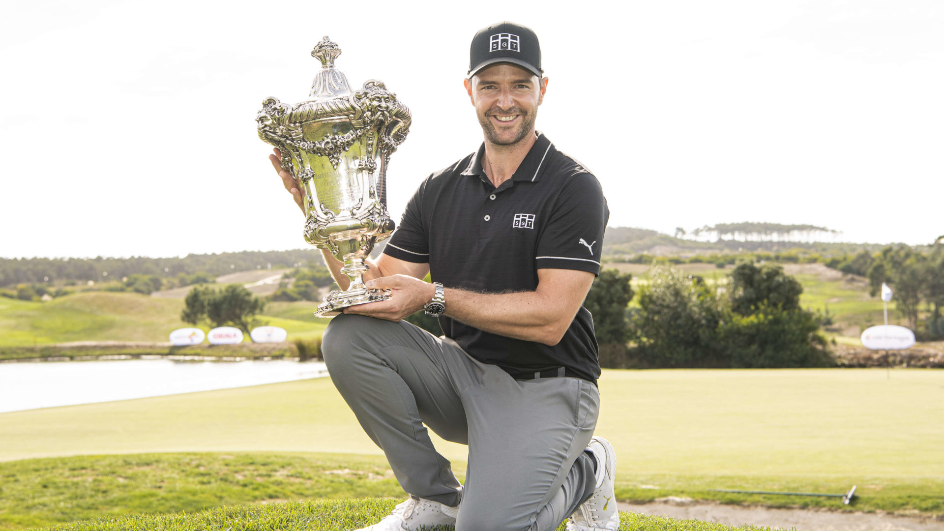 OBIDOS, PORTUGAL - SEPTEMBER 26: Marcel Schneider of Germany poses at the 18th green with the Trophy after winning the Open de Portugal at Royal Obidos at Royal Obidos Spa & Golf Resort on September 26, 2021 in Obidos, Portugal. (Photo by Octavio Passos/Getty Images)