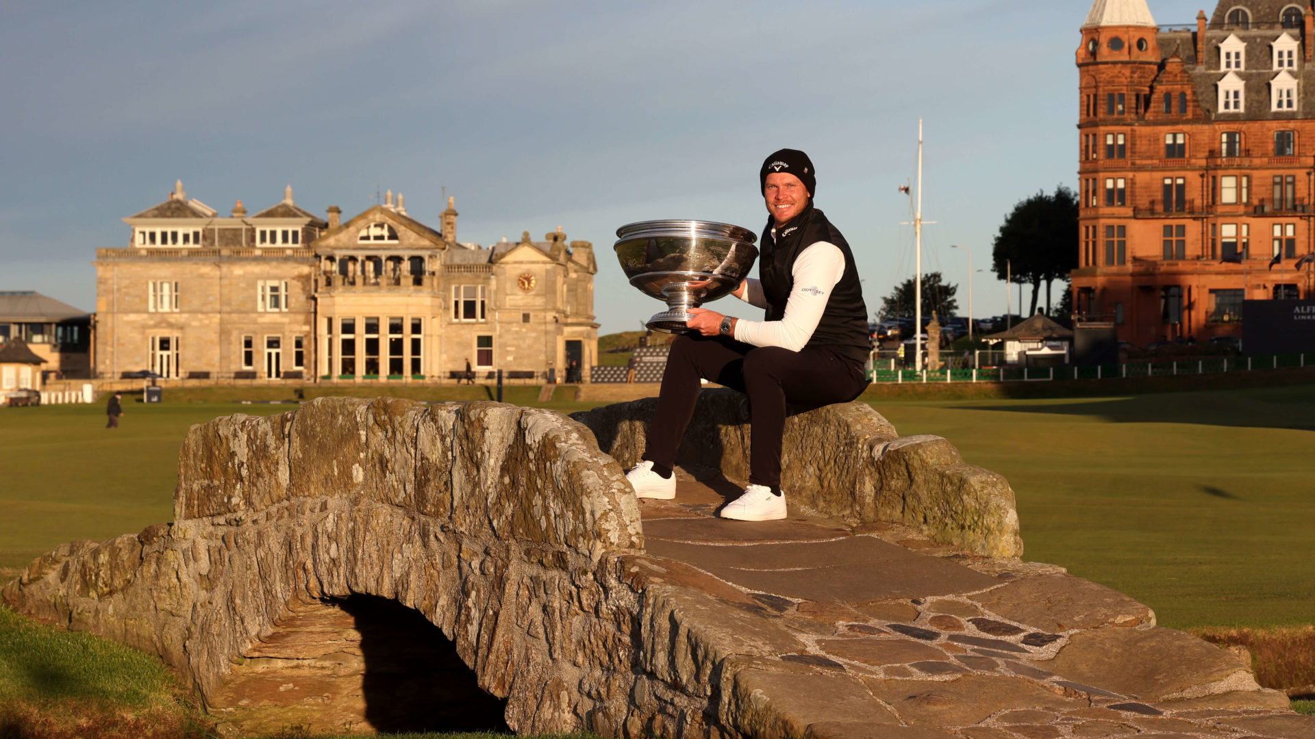 ST ANDREWS, SCOTLAND - OCTOBER 03: Danny Willett of England poses with the trophy on the Swilcan Bridge on the 18th hole following victory during Day Four of The Alfred Dunhill Links Championship at The Old Course on October 03, 2021 in St Andrews, Scotland. (Photo by Matthew Lewis/Getty Images)