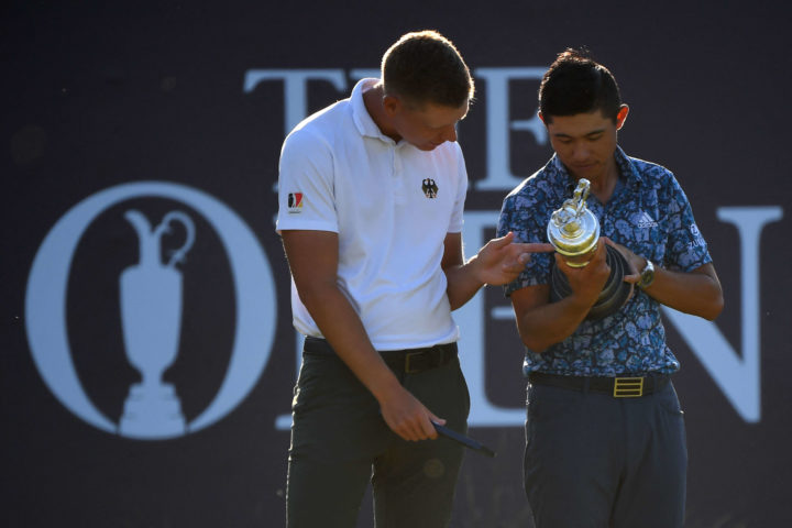 Germany's amateur golfer Matthias Schmid (L) with his silver medal after finishing as top amateur looks at the Claret Jug with Champion Golfer of the Year US golfer Collin Morikawa (R) during the presentation on the final day of The 149th British Open Golf Championship at Royal St George's, Sandwich in south-east England on July 18, 2021. - - RESTRICTED TO EDITORIAL USE (Photo by ANDY BUCHANAN / AFP) / RESTRICTED TO EDITORIAL USE (Photo by ANDY BUCHANAN/AFP via Getty Images)