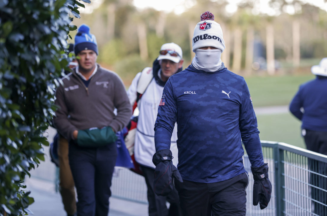 PONTE VEDRA BEACH, FL - MARCH 13: Gary Woodland walks bundled up in frigid temperatures to continue his second round of THE PLAYERS Championship on THE PLAYERS Stadium Course at TPC Sawgrass on March 13, 2022, in Ponte Vedra Beach, FL. (Photo by Logan Bowles/PGA TOUR via Getty Images)