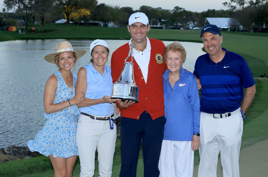 ORLANDO, FLORIDA - MARCH 06: Scottie Scheffler of The United States holds the trophy with his wife Meredith Scheffler (L) mother Diane Scheffler, father Scott Scheffler and grandmother after his one stroke win in the final round of the Arnold Palmer Invitational presented by Mastercard at Arnold Palmer Bay Hill Golf Course on March 06, 2022 in Orlando, Florida. tour news (Photo by David Cannon/Getty Images)