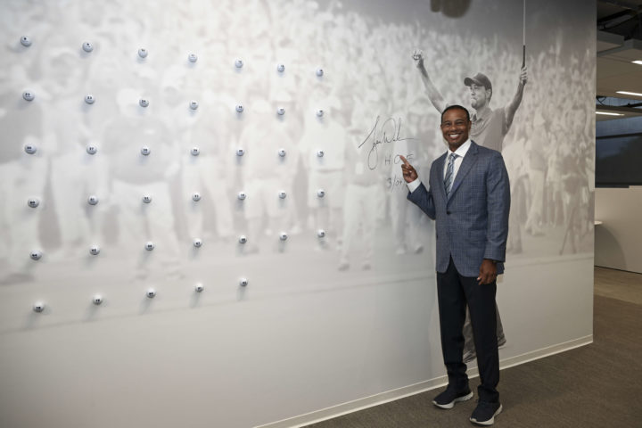 PONTE VEDRA BEACH, FL - MARCH 09: World Golf Hall of Fame inductee, Tiger Woods, signs a wall graphic of himself ahead of the World Golf Hall of Fame Induction Ceremony prior to THE PLAYERS Championship at PGA TOUR Global Home on March 9, 2022, in Ponte Vedra Beach, FL. (Photo by Chris Condon/PGA TOUR via Getty Images)