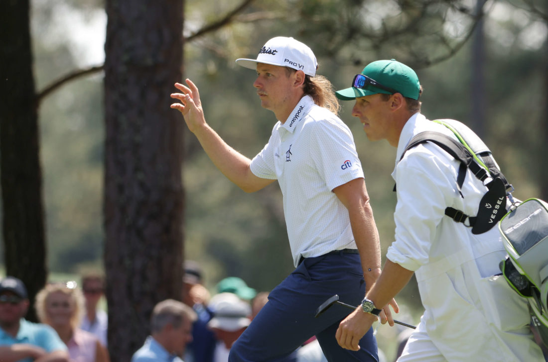 AUGUSTA, GEORGIA - APRIL 07: Cameron Smith of Australia waves to the crowd while walking across the sixth hole during the first round of the Masters at Augusta National Golf Club on April 07, 2022 in Augusta, Georgia. (Photo by Jamie Squire/Getty Images)