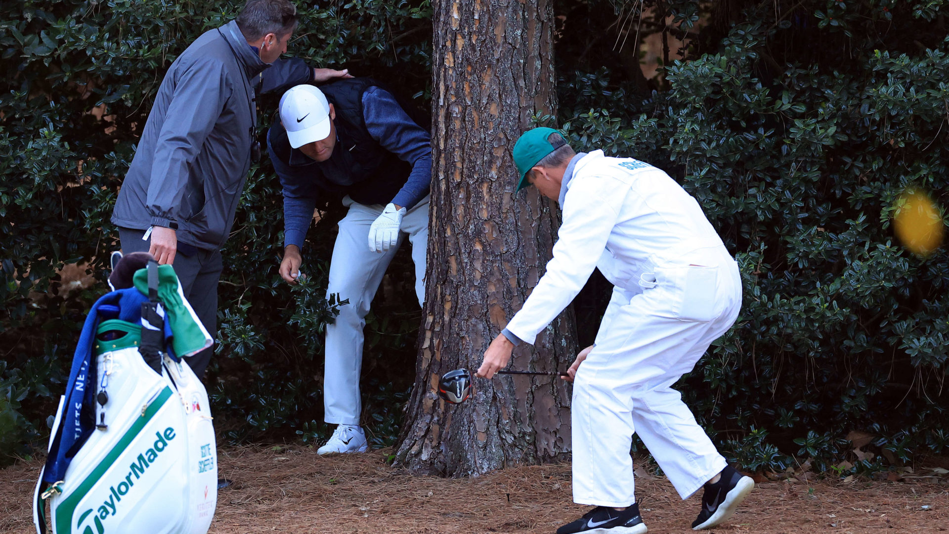 AUGUSTA, GEORGIA - APRIL 09: Scottie Scheffler prepares to take a drop on the 18th hole during the third round of the Masters at Augusta National Golf Club on April 09, 2022 in Augusta, Georgia. (Photo by David Cannon/Getty Images)