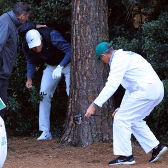 AUGUSTA, GEORGIA - APRIL 09: Scottie Scheffler prepares to take a drop on the 18th hole during the third round of the Masters at Augusta National Golf Club on April 09, 2022 in Augusta, Georgia. (Photo by David Cannon/Getty Images)