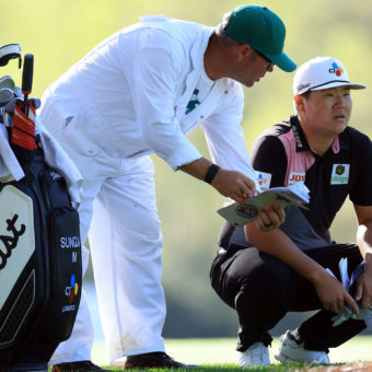 AUGUSTA, GEORGIA - APRIL 07: Sungjae Im of South Korea and caddie William Spencer line up a shot on the 14th hole during the first round of the Masters at Augusta National Golf Club on April 07, 2022 in Augusta, Georgia. (Photo by David Cannon/Getty Images)