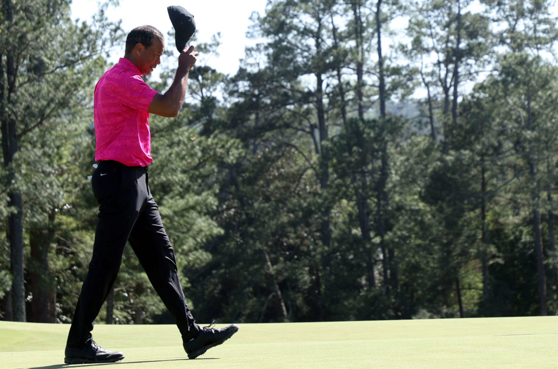 Tiger Woods tips his hat to the crowd on the 18th green after finishing his round during the first round of the Masters at Augusta National Golf Club on April 07, 2022 in Augusta, Georgia. (Photo by Jamie Squire/Getty Images)