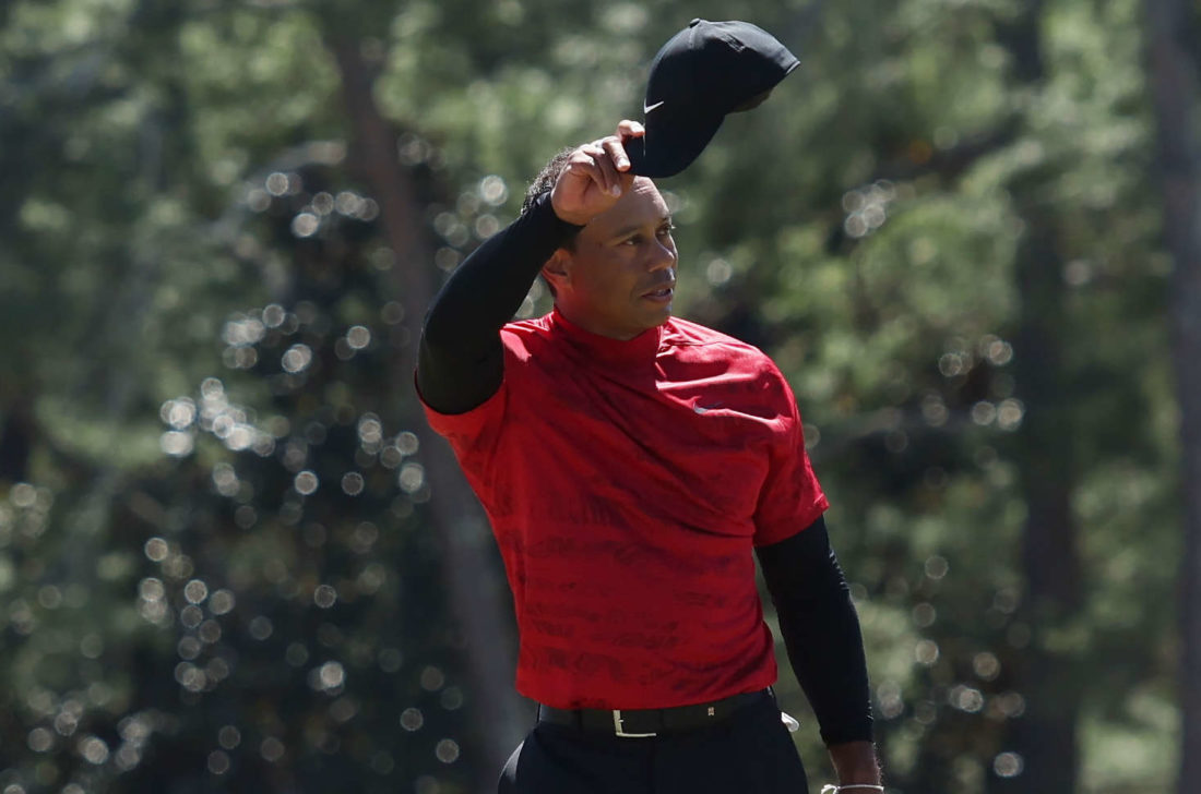 AUGUSTA, GEORGIA - APRIL 10: Tiger Woods tips his hat to the crowd on the 18th green after finishing his round during the final round of the Masters at Augusta National Golf Club on April 10, 2022 in Augusta, Georgia. (Photo by Gregory Shamus/Getty Images)