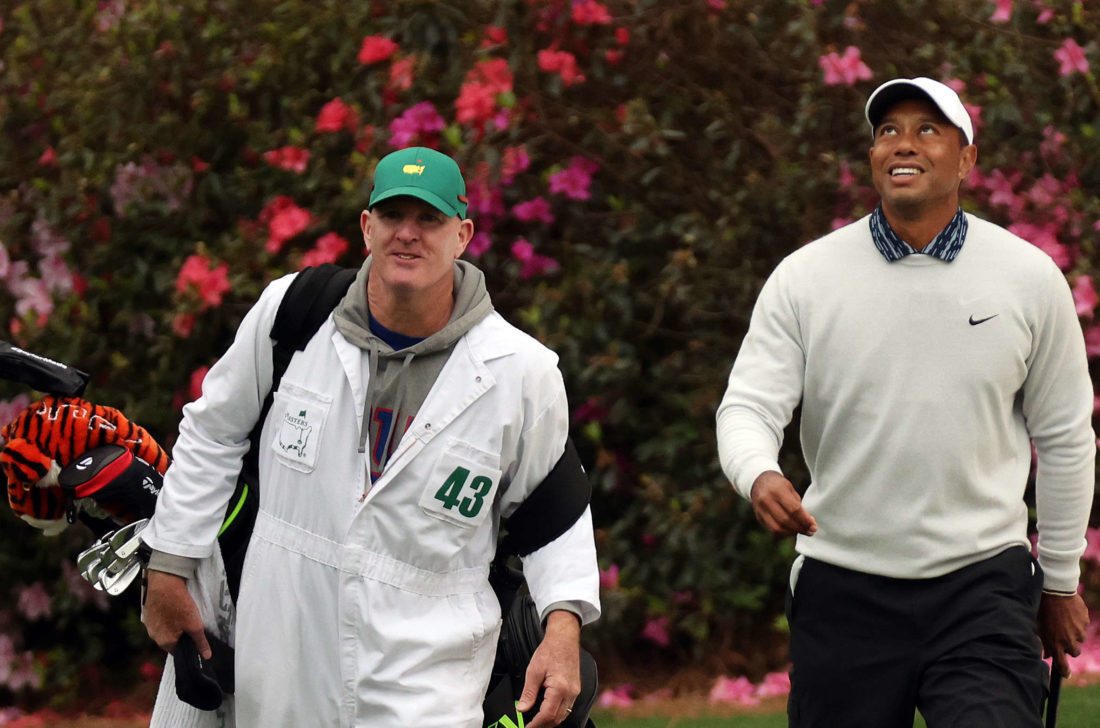 AUGUSTA, GEORGIA - APRIL 09: Tiger Woods and caddie Joe LaCava walk off the 13th green after making birdie during the third round of the Masters at Augusta National Golf Club on April 09, 2022 in Augusta, Georgia. (Photo by Gregory Shamus/Getty Images)