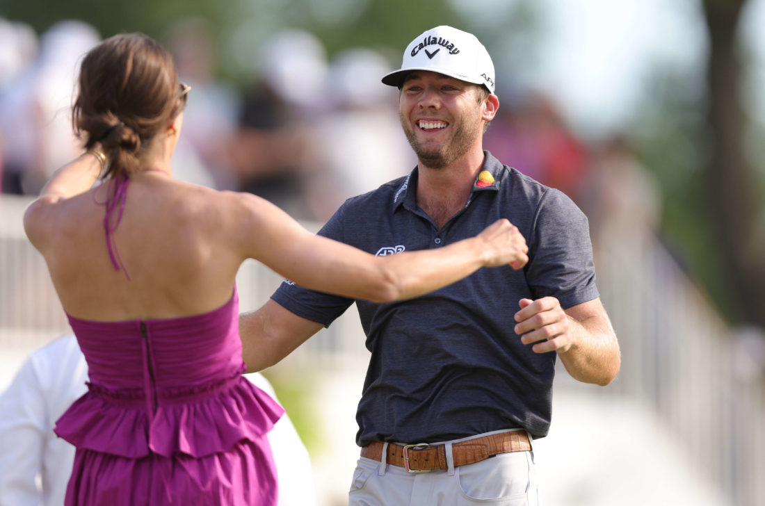 FORT WORTH, TEXAS - MAY 29: Sam Burns of the United States reacts with his wife Caroline Campbell after putting in to win the Charles Schwab Challenge during the first playoff hole on the 18th green during the final round of the Charles Schwab Challenge at Colonial Country Club on May 29, 2022 in Fort Worth, Texas. tour news (Photo by Carmen Mandato/Getty Images)