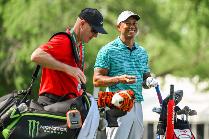 TULSA, OK - MAY 15: Tiger Woods smiles next to his bag and caddie Joe LaCava during practice for the PGA Championship at Southern Hills Country Club on May 15, 2022, in Tulsa, Oklahoma. (Photo by Keyur Khamar/PGA TOUR via Getty Images)
