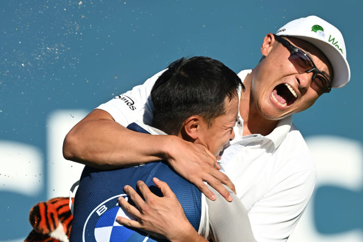 MUNICH, GERMANY - tour news JUNE 26: Haotong Li of China celebrates with their caddie on the 18th hole following the playoff during Day Four of the BMW International Open at Golfclub Munchen Eichenried on June 26, 2022 in Munich, Germany. (Photo by Stuart Franklin/Getty Images)