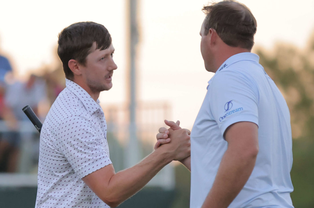 JACKSON, MISSISSIPPI - tour news OCTOBER 02: Mackenzie Hughes of Canada shakes hands with Sepp Straka of Austria on the 18th green after putting in to win on the second playoff hole during the final round of the Sanderson Farms Championship at The Country Club of Jackson on October 02, 2022 in Jackson, Mississippi. (Photo by Jonathan Bachman/Getty Images)