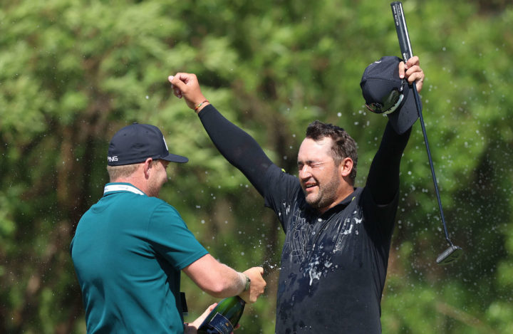 JOHANNESBURG, SOUTH AFRICA - DECEMBER 04: Thriston Lawrence of South Africa celebrates his win as he is sprayed with champagne by sunshine tour professional Albert Venter on the 18th green during Day Four of the Investec South African Open Championship at Blair Atholl Golf & Equestrian Estate on December 04, 2022 in Johannesburg, South Africa. tour news (Photo by Luke Walker/Getty Images)