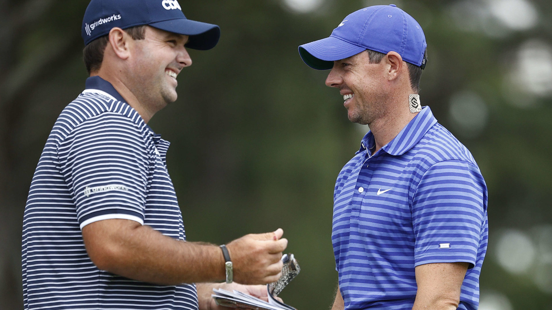 CHARLOTTE, NORTH CAROLINA - MAY 06: (L-R) Patrick Reed of the United States and Rory McIlroy of Northern Ireland smile on the ninth green during the first round of the 2021 Wells Fargo Championship at Quail Hollow Club on May 06, 2021 in Charlotte, North Carolina. (Photo by Maddie Meyer/Getty Images)