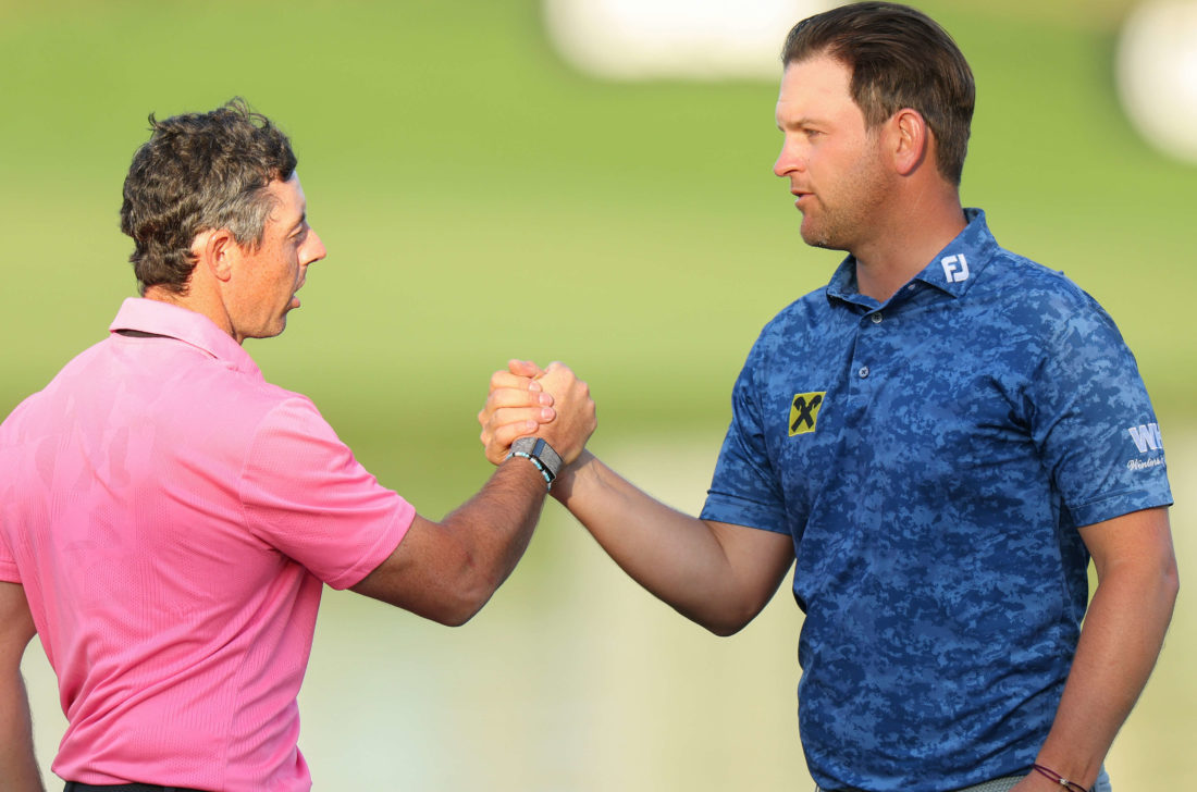 DUBAI, UNITED ARAB EMIRATES - JANUARY 29: Rory McIlroy of Northern Ireland and Bernd Wiesberger of Austria shake hands on the 18th green during the Third Round on Day Four of the Hero Dubai Desert Classic at Emirates Golf Club on January 29, 2023 in Dubai, United Arab Emirates. tour news (Photo by Andrew Redington/Getty Images)