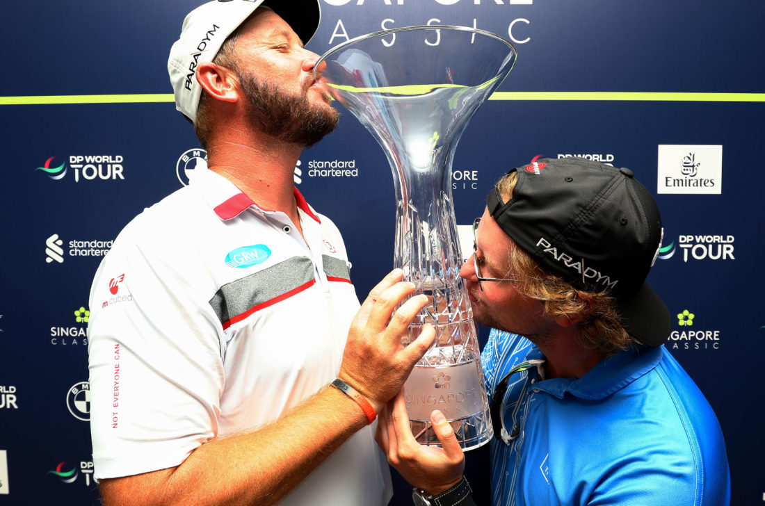SINGAPORE, SINGAPORE - FEBRUARY 12: Ockie Strydom of South Africa and his caddie Jaris Kruger pose for photos with the Singapore Classic trophy during Day Four of the Singapore Classic at Laguna National Golf Resort Club on February 12, 2023 in Singapore. (Photo by Yong Teck Lim/Getty Images) tour news