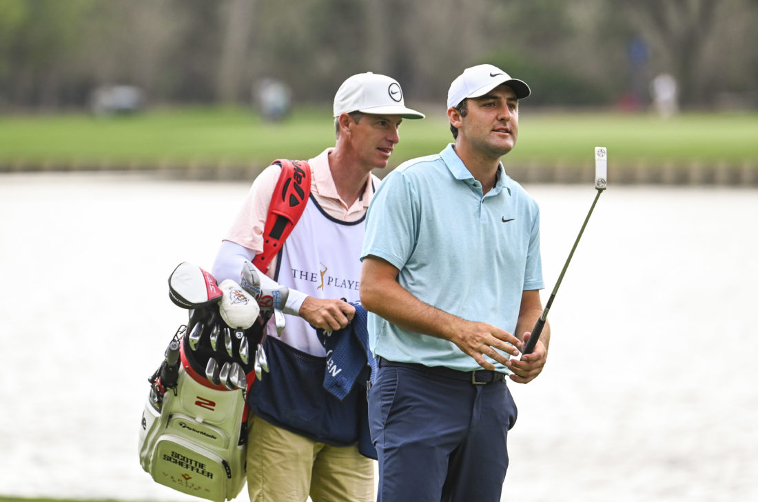 PONTE VEDRA BEACH, FLORIDA - MARCH 12: Scottie Scheffler smiles with his caddie Ted Scott and his bag on the 18th hole fairway during the final round of THE PLAYERS Championship on the Stadium Course at TPC Sawgrass on March 12, 2023 in Ponte Vedra Beach, Florida. (Photo by Keyur KhamarPGA TOUR via Getty Images) tour new s