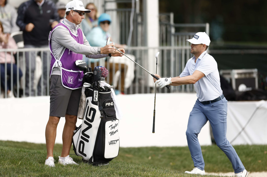 PALM HARBOR, FLORIDA - MARCH 19: Taylor Moore of the United States exchanges clubs with caddie Chris Tichenor after hitting from a bunker on the 17th hole during the final round of the Valspar Championship at Innisbrook Resort and Golf Club on March 19, 2023 in Palm Harbor, Florida. (Photo by Douglas P. DeFelice/Getty Images) tour news