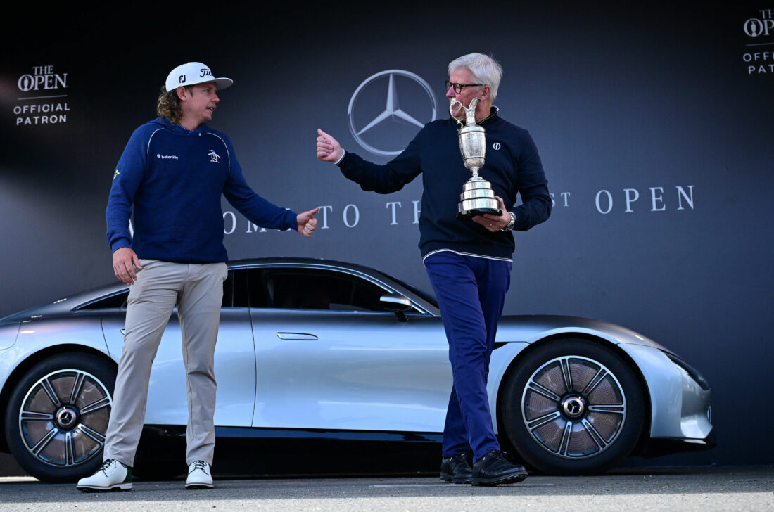 Australia's Cameron Smith (L) returns to the Claret Jug, the trophy for the Champion Golfer of the Year, to The R&A CEO Martin Slumbers, during a photocall ahead of the 151st British Open Golf Championship at Royal Liverpool Golf Course in Hoylake, north west England on July 17, 2023. Smith won the 150th Open in 2022. The Royal Liverpool Golf Course will host The 151st Open from July 20 to 23, 2023. (Photo by Ben Stansall / AFP) / EDITORIAL USE ONLY (Photo by BEN STANSALL/AFP via Getty Images)