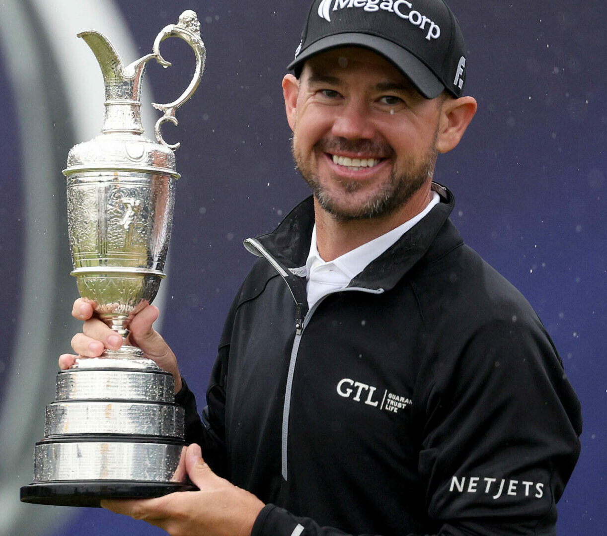 HOYLAKE, ENGLAND - JULY 23: Brian Harman of the United States poses for a photograph with the Claret Jug on the 18th green after winning The 151st Open on Day Four of The 151st Open at Royal Liverpool Golf Club on July 23, 2023 in Hoylake, England. (Photo by Warren Little/Getty Images)