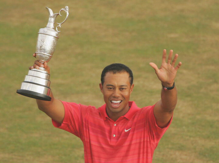 HOYLAKE, UNITED KINGDOM - JULY 23: Tiger Woods of USA celebrates with the claret jug following his two shot victory at the end of the final round of The Open Championship at Royal Liverpool Golf Club on July 23, 2006 in Hoylake, England. (Photo by Warren Little/Getty Images)