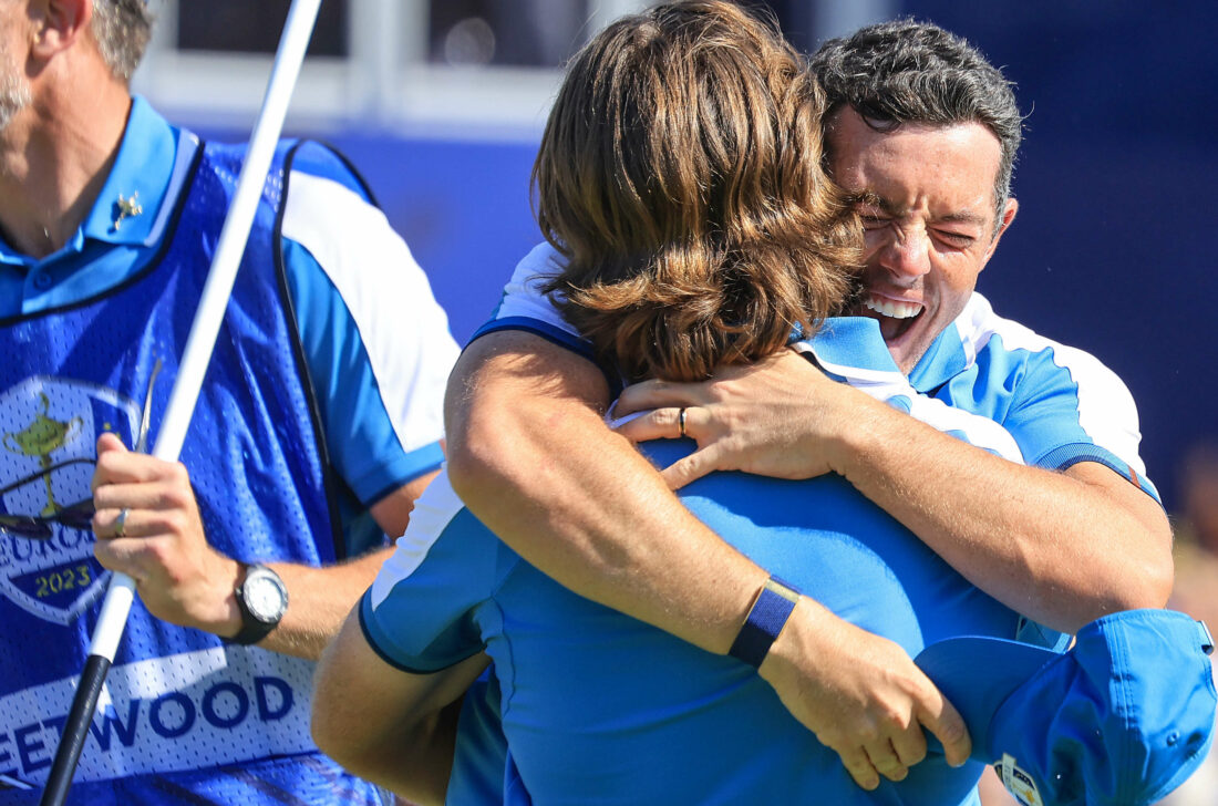 ROME, ITALY - SEPTEMBER 29: Rory McIlroy of Northern Ireland and The European Team leaps into the arms of his partner Tommy Fleetwood after they had won their match on the 17th green against Xander Schauffele and Patrick Cantlay during the Friday morning foursomes matches of the 2023 Ryder Cup at Marco Simone Golf Club on September 29, 2023 in Rome, Italy. (Photo by David Cannon/Getty Images)