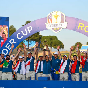 Team Europe captain Luke Donald, centre, lifts the cup with his team, from left, Tommy Fleetwood, Sepp Straka, Shane Lowry, Matt Fitzpatrick, Justin Rose, Tyrrell Hatton, Nicolai Højgaard, Rory McIlroy, Viktor Hovland, Ludvig Åberg, Robert MacIntyre and Jon Rahm during the singles matches on the final day of the 2023 Ryder Cup at Marco Simone Golf and Country Club in Rome, Italy. (Photo By Brendan Moran/Sportsfile via Getty Images)