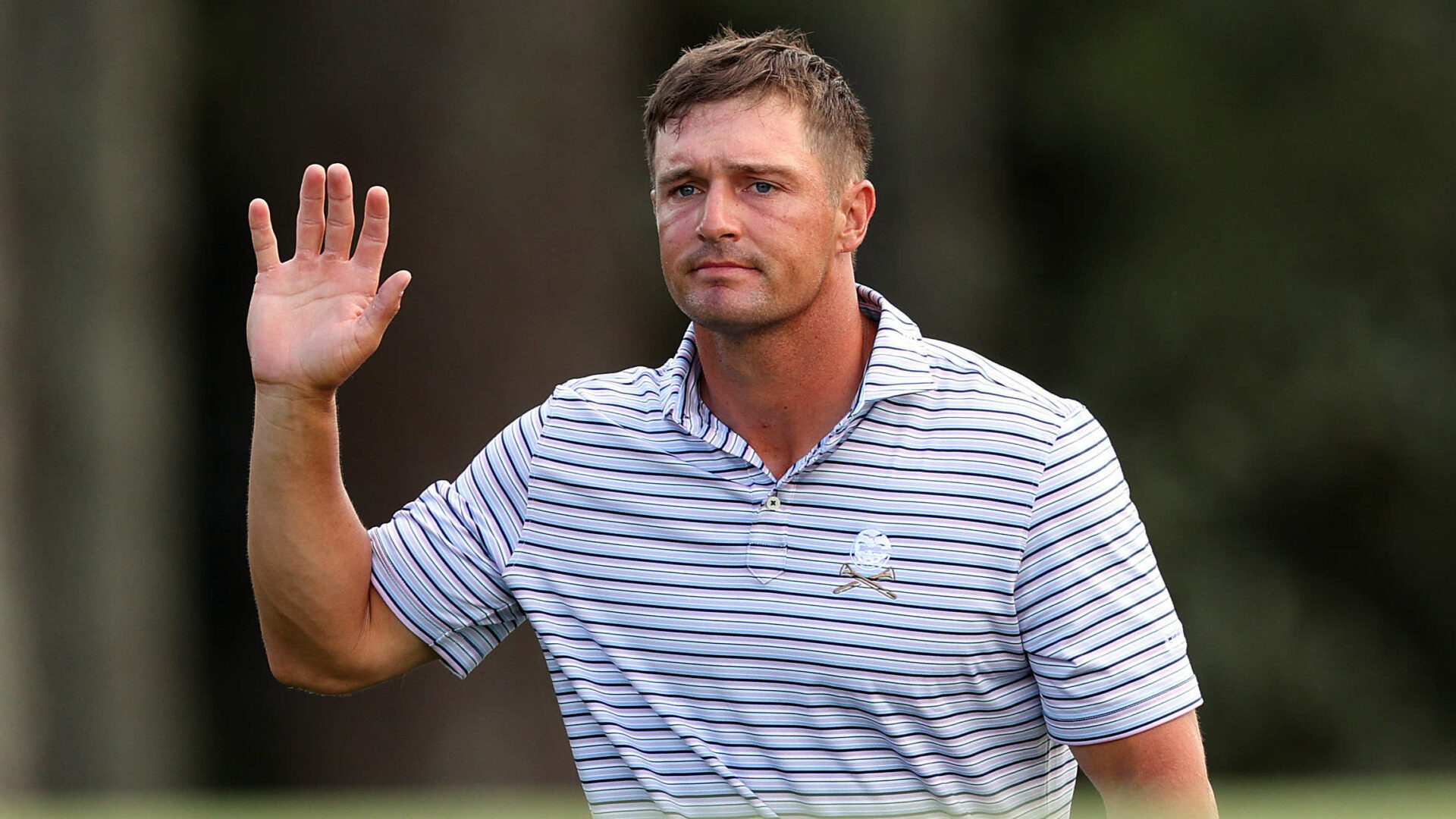 AUGUSTA, GEORGIA - APRIL 11: Bryson DeChambeau of the United States waves to the patrons on the 18th green during the first round of the 2024 Masters Tournament at Augusta National Golf Club on April 11, 2024 in Augusta, Georgia. (Photo by Andrew Redington/Getty Images)