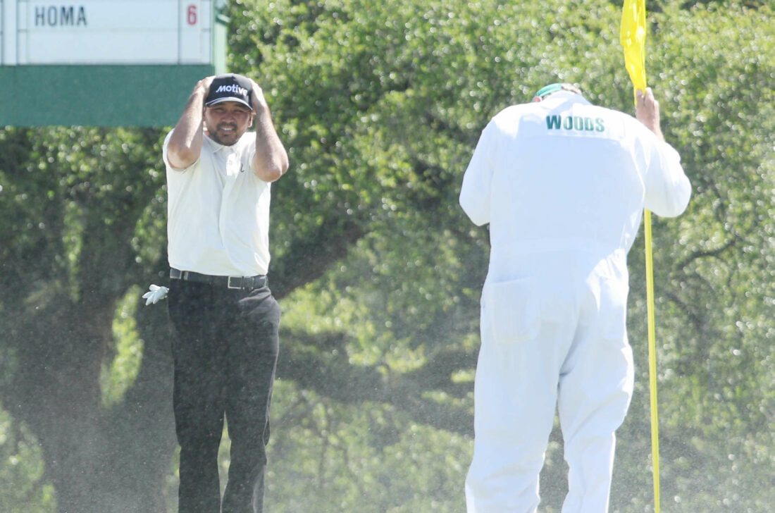 AUGUSTA, GEORGIA - APRIL 12: Jason Day of Australia shields his face from the blowing sand on the 18th green during the second round of the 2024 Masters Tournament at Augusta National Golf Club on April 12, 2024 in Augusta, Georgia. (Photo by Warren Little/Getty Images)