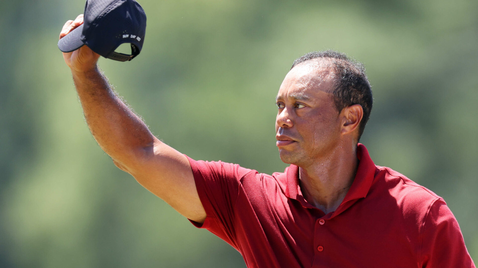 AUGUSTA, GEORGIA - APRIL 14: Tiger Woods of the United States waves his hat to the crowd while walking to the 18th green during the final round of the 2024 Masters Tournament at Augusta National Golf Club on April 14, 2024 in Augusta, Georgia. (Photo by Andrew Redington/Getty Images)