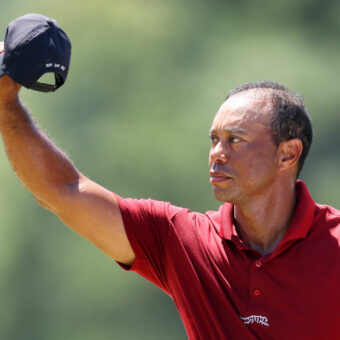 AUGUSTA, GEORGIA - APRIL 14: Tiger Woods of the United States waves his hat to the crowd while walking to the 18th green during the final round of the 2024 Masters Tournament at Augusta National Golf Club on April 14, 2024 in Augusta, Georgia. (Photo by Andrew Redington/Getty Images)