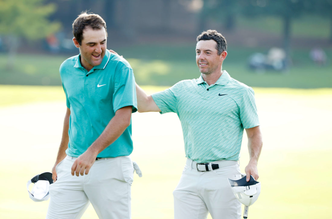 ATLANTA, GEORGIA - AUGUST 28: Scottie Scheffler of the United States congratulates Rory McIlroy of Northern Ireland on the 18th green after McIlroy won during the final round of the TOUR Championship at East Lake Golf Club on August 28, 2022 in Atlanta, Georgia. (Photo by Cliff Hawkins/Getty Images)