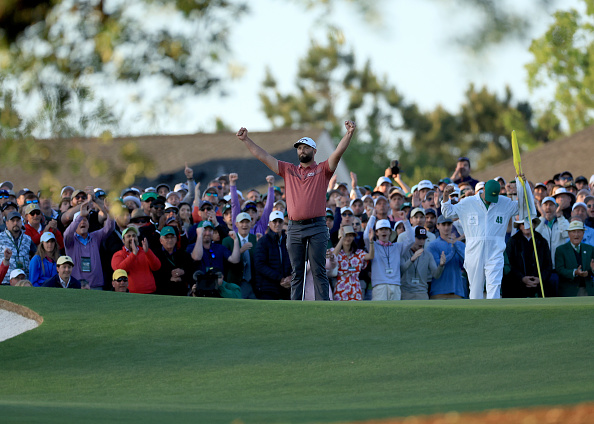 AUGUSTA, GEORGIA - APRIL 09: Jon Rahm of Spain celebrates holing the winning putt on the 18th green as his caddie Adam Hayes looks on during the final round of the 2023 Masters Tournament at Augusta National Golf Club on April 09, 2023 in Augusta, Georgia. (Photo by David Cannon/Getty Images)