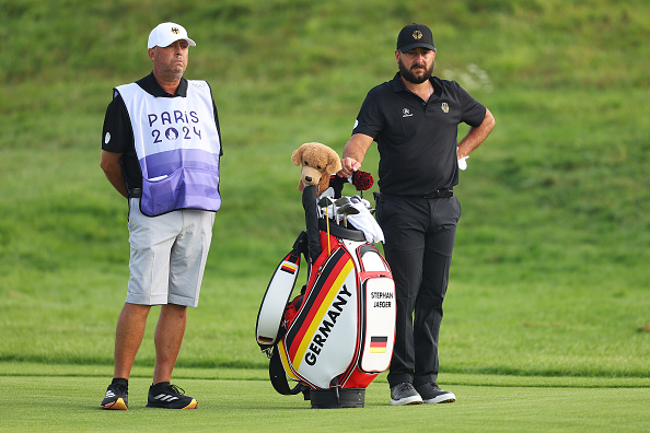 Stephan Jaeger waits on the third hole alongside his caddie during Day Two of the Men's Individual Stroke Play - Olympic Games Paris 2024 at Le Golf National