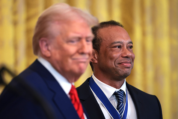 WASHINGTON, DC - FEBRUARY 20: Gold legend Tiger Woods stands alongside U.S. President Donald Trump during a reception honoring Black History Month in the East Room of the White House on February 20, 2025 in Washington, DC. The Black History Month celebration comes as Trump has signed a series of executive orders ending federal diversity, equity and inclusion (DEI) programs and cutting funding to schools and Universities that do not cut DEI programs. (Photo by Win McNamee/Getty Images)