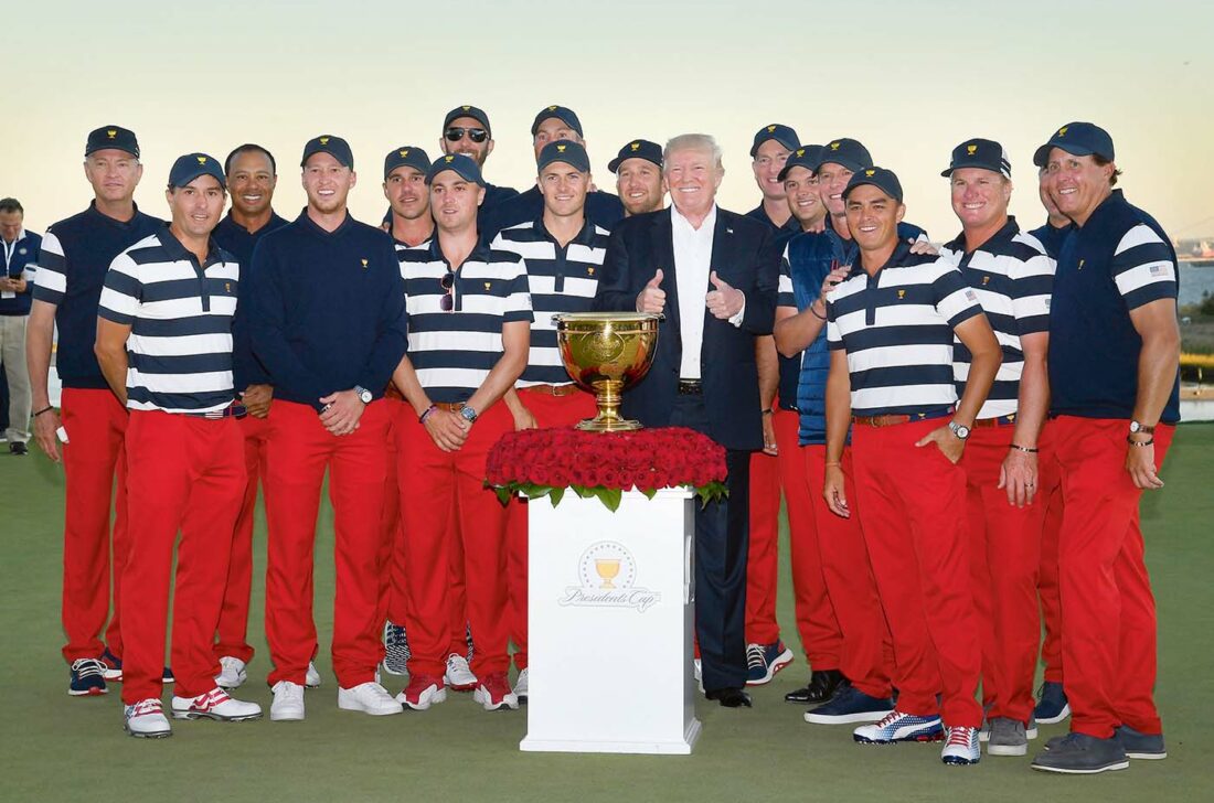 JERSEY CITY, NJ - OCTOBER 01: President Donald Trump and members of the U.S. Team pose with the trophy after the U.S. Team defeated the International Team 19 to 11 in the Presidents Cup at Liberty National Golf Club on October 1, 2017, in Jersey City, New Jersey. (Photo by Chris Condon/PGA TOUR)