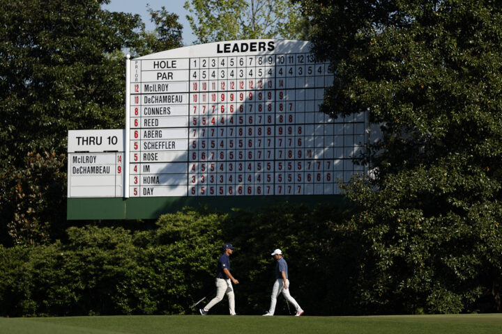 AUGUSTA, GEORGIA - APRIL 13: (R-L) Rory McIlroy of Northern Ireland and Bryson DeChambeau of the United States walk near the leaderboard on the 11th green during the final round of the 2025 Masters Tournament at Augusta National Golf Club on April 13, 2025 in Augusta, Georgia. (Photo by Harry How/Getty Images)
