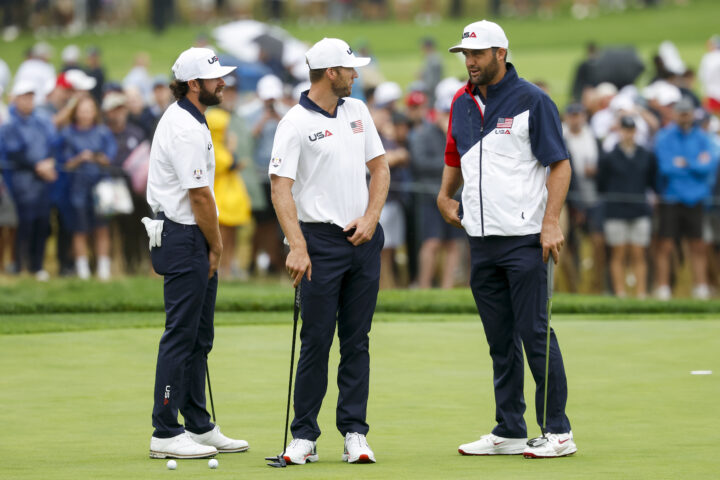 FARMINGDALE, NEW YORK - SEPTEMBER 25: Scottie Scheffler of Team United States talks with teammates Sam Burns and Cameron Young during a practice round prior to the Ryder Cup 2025 at Black Course at Bethpage State Park Golf Course on September 25, 2025 in Farmingdale, New York. (Photo by Harry How/Getty Images)