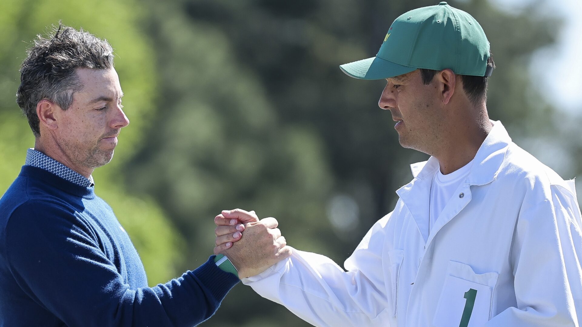 AUGUSTA, GEORGIA - APRIL 09: Rory McIlroy of Northern Ireland and his caddie Harry Diamond shake hands on the 18th green during the first round of the 2026 Masters Tournament at Augusta National Golf Club on April 09, 2026 in Augusta, Georgia. (Photo by Hector Vivas/Getty Images)